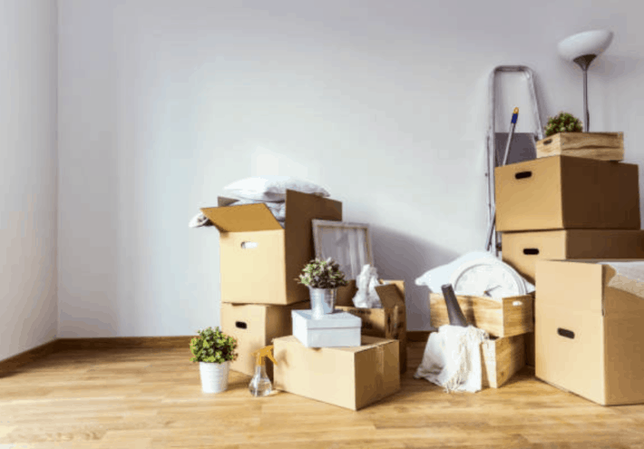 Stack of moving boxes and items on top of them