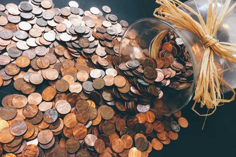 Coins spilled out of a jar. - cheap apartment in Nashville featured image