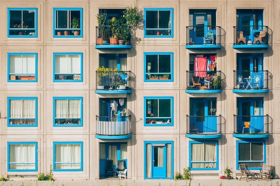 A building with blue windows and balconies.