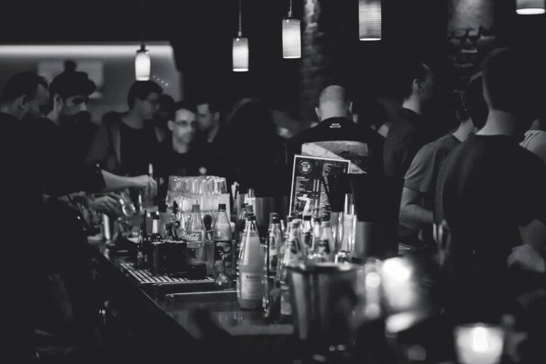 Sports bar with people enjoying cold beverages
