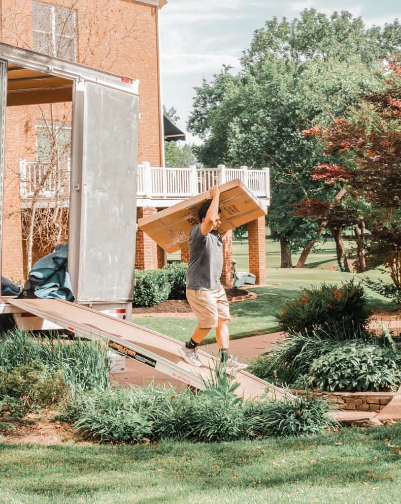 A few Move On movers carrying items out of a home