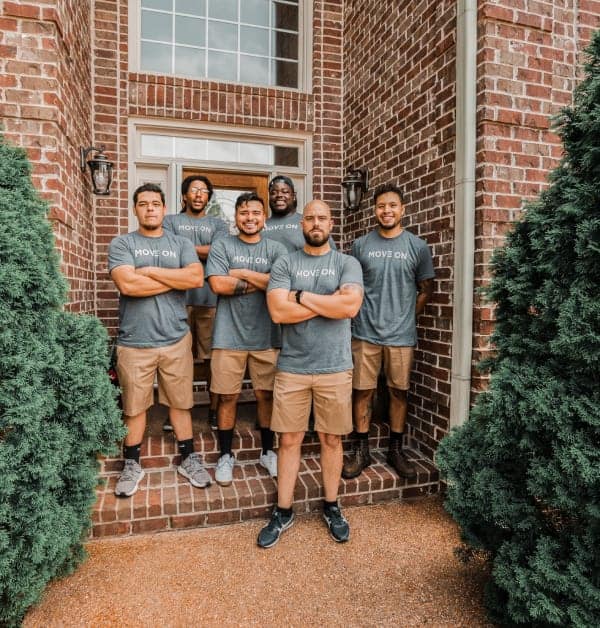 Move On relocation team standing and smiling with their arms crossed