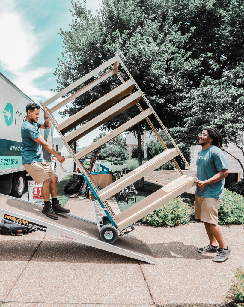 Image of two Move On movers loading an item onto a moving truck